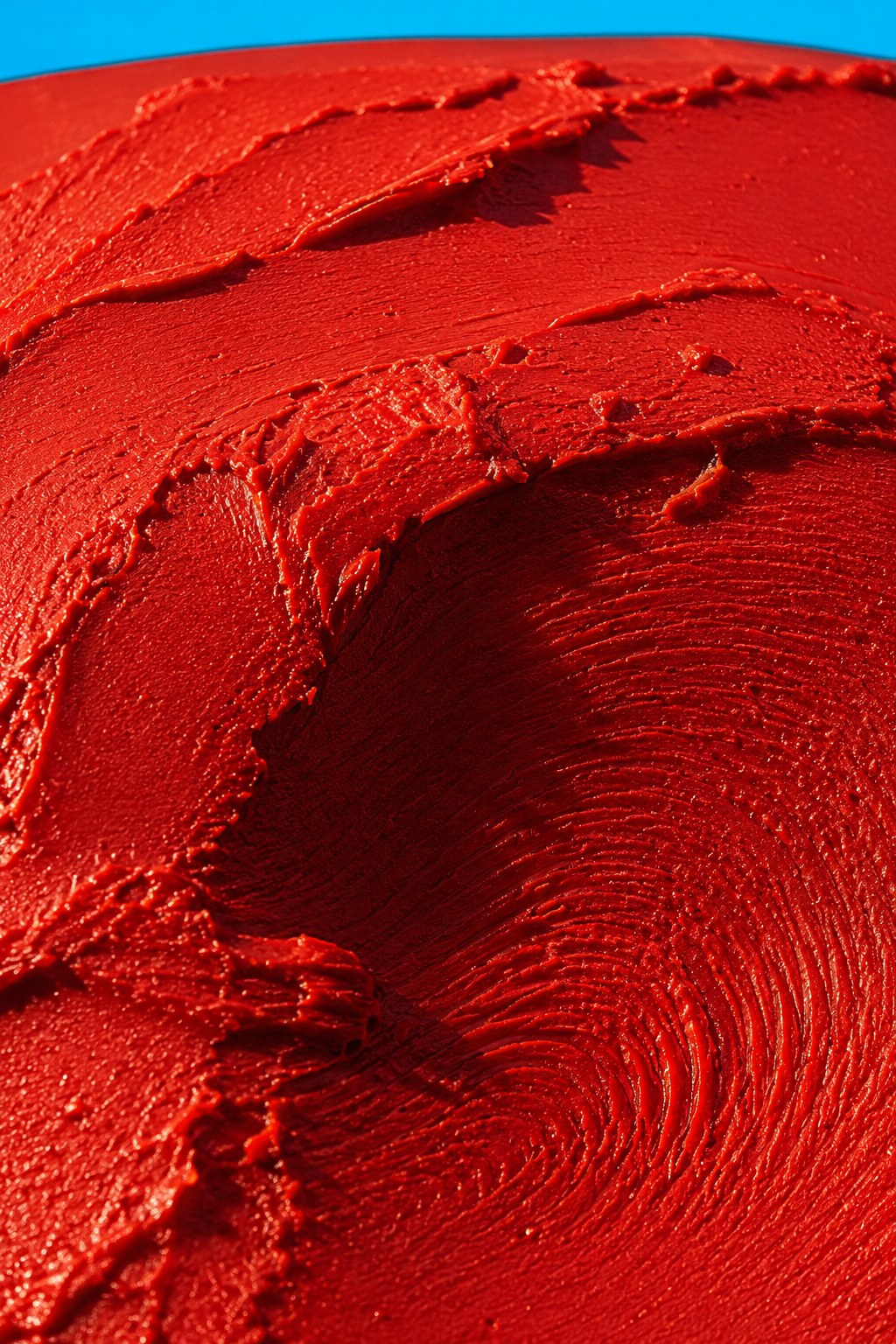 A close study of sculpted scarlet pigment and its tactile surface